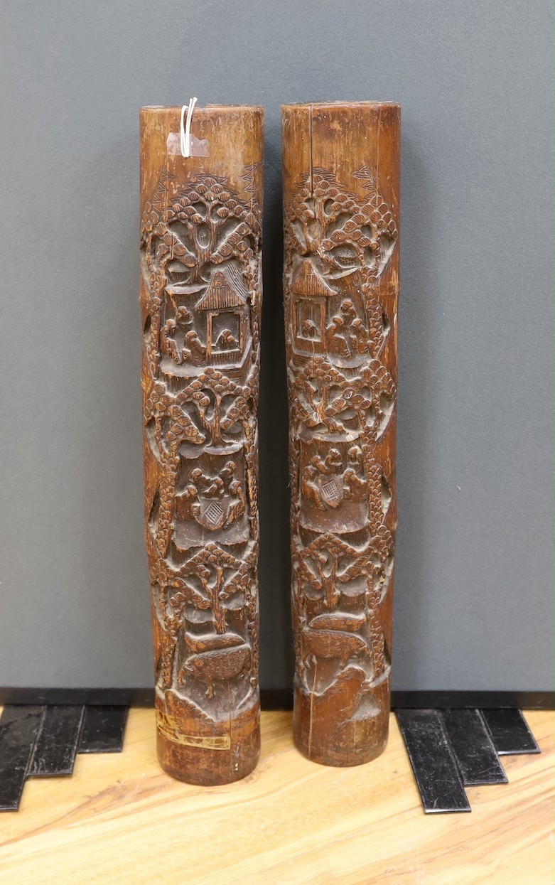 A pair of early 20th century Chinese carved bamboo chutes, 70cm